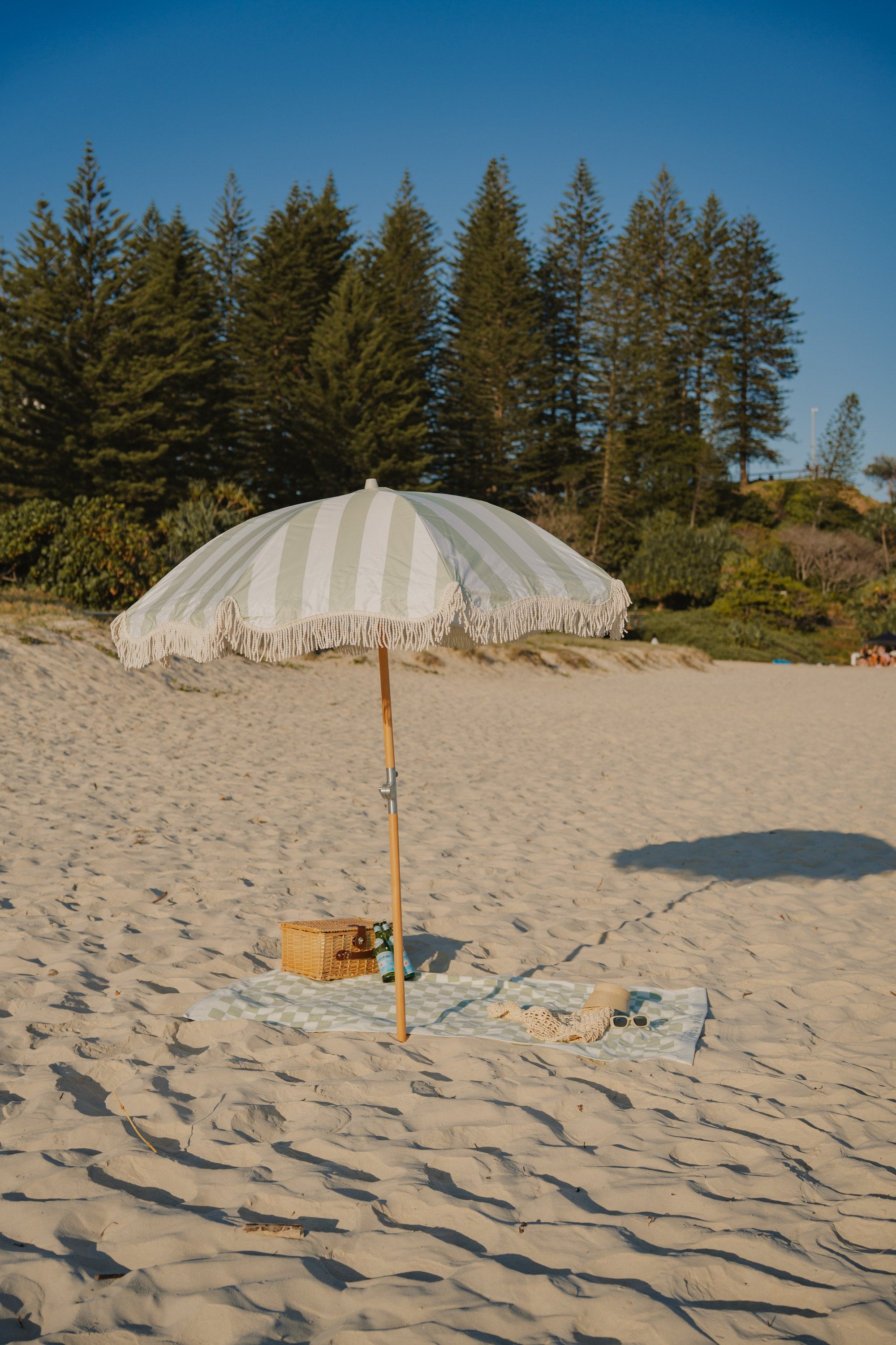Salted Sage Beach Umbrella on the sand