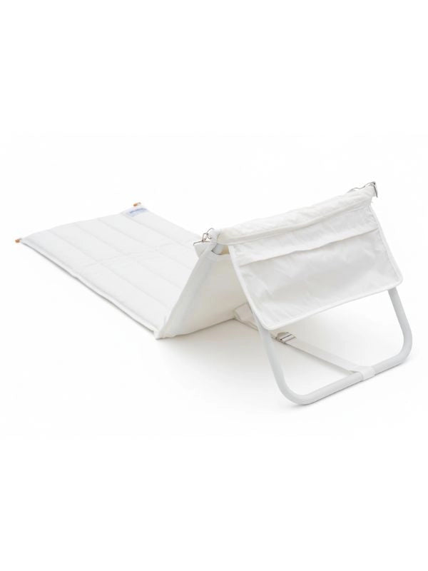 Side view of the House of Dune Oyster Tide beach lounger, showing the folding aluminium frame and backrest pocket.