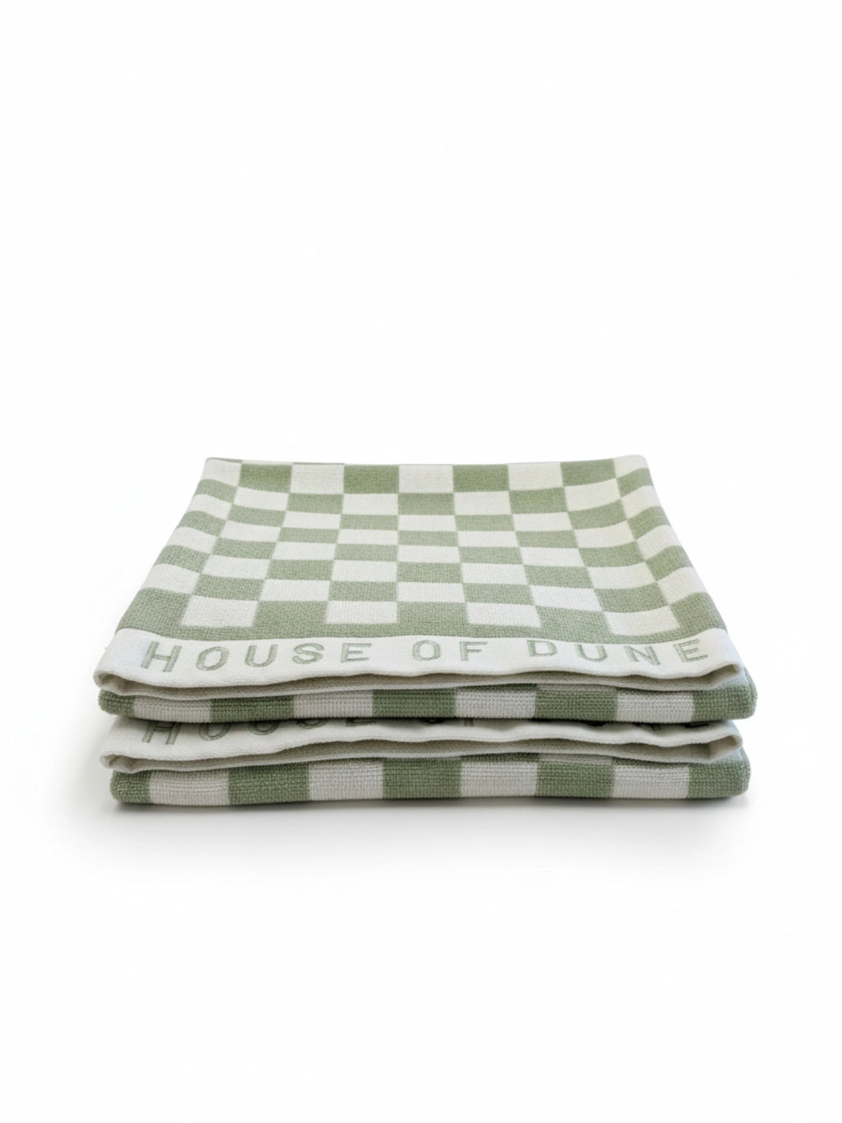 Set of two House of Dune Salted Sage beach towels with green and white checkerboard pattern neatly folded on a white surface.