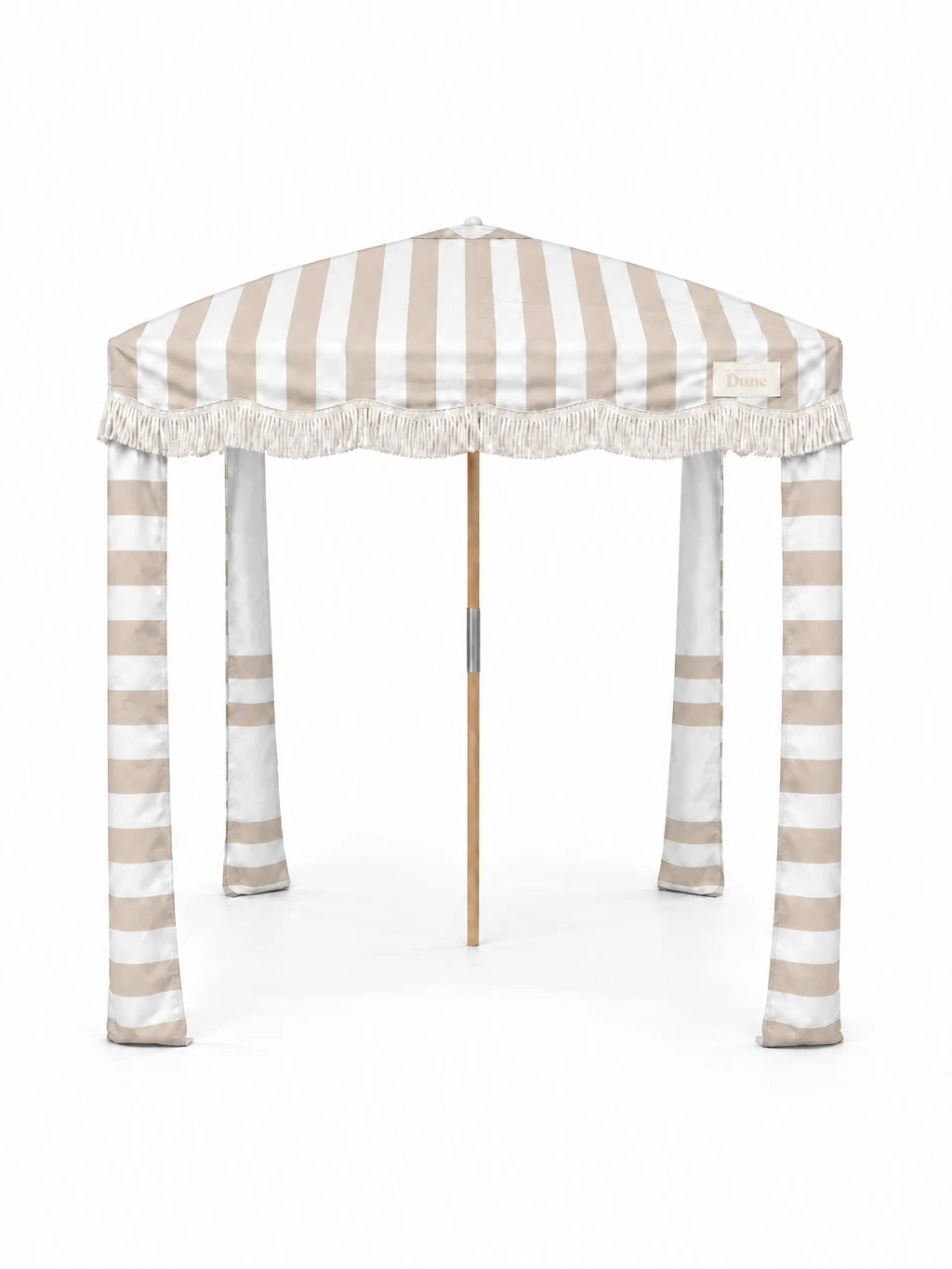 House of Dune Sand Drift beach cabana, front view on white: sand and white striped canopy, off-white fringe, striped fabric legs and a wooden centre pole.