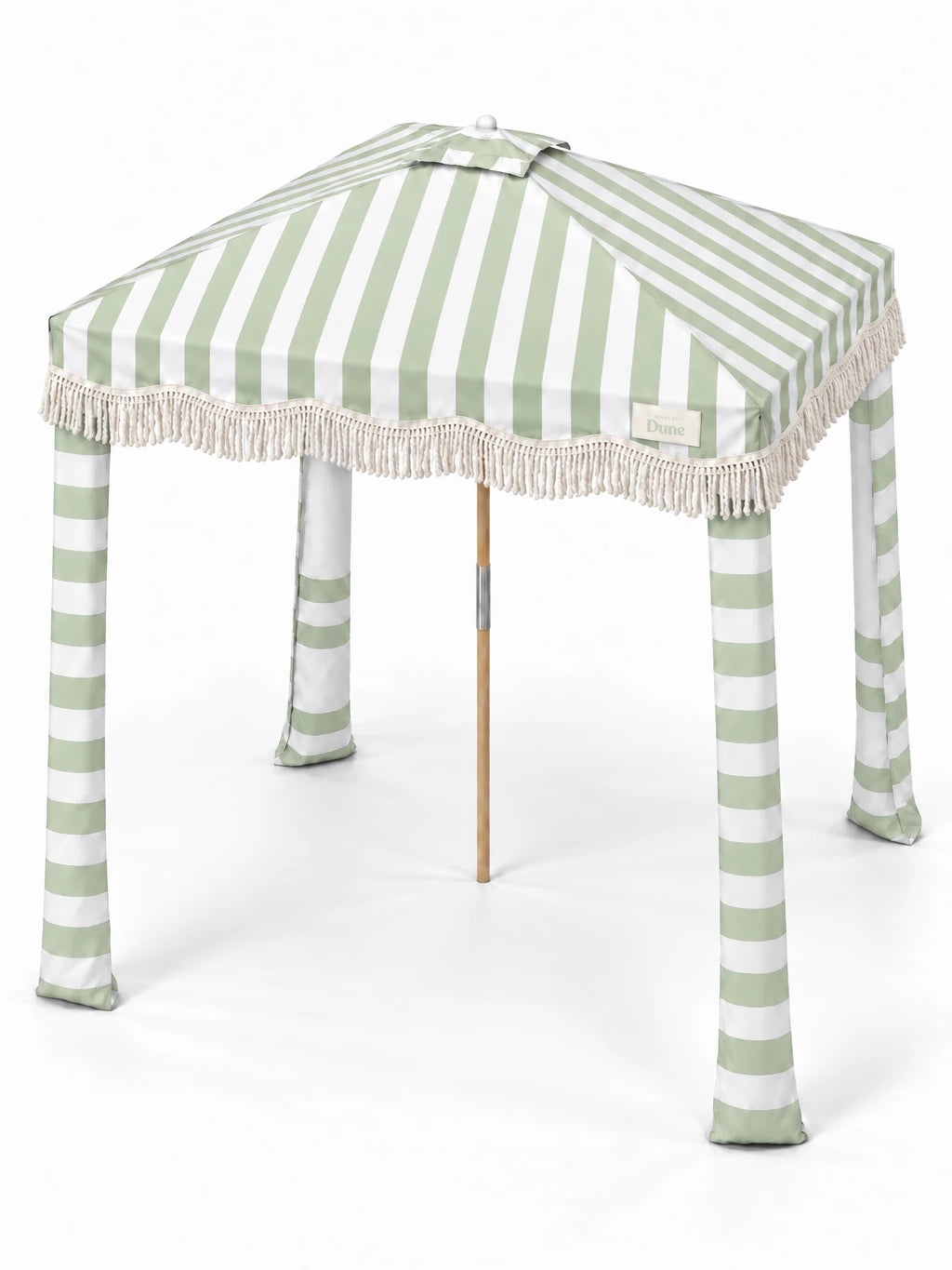 House of Dune Salted Sage beach cabana from a raised three-quarter angle, showing the striped roof panels, central vent, fringe and four fabric legs.