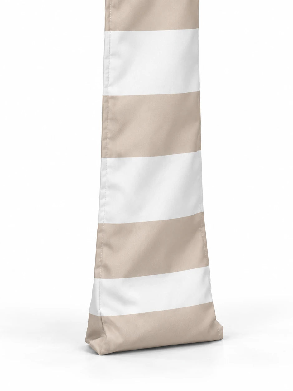 Foot of a House of Dune Sand Drift cabana leg: soft sand and white striped fabric with a stitched base that sits on the sand.