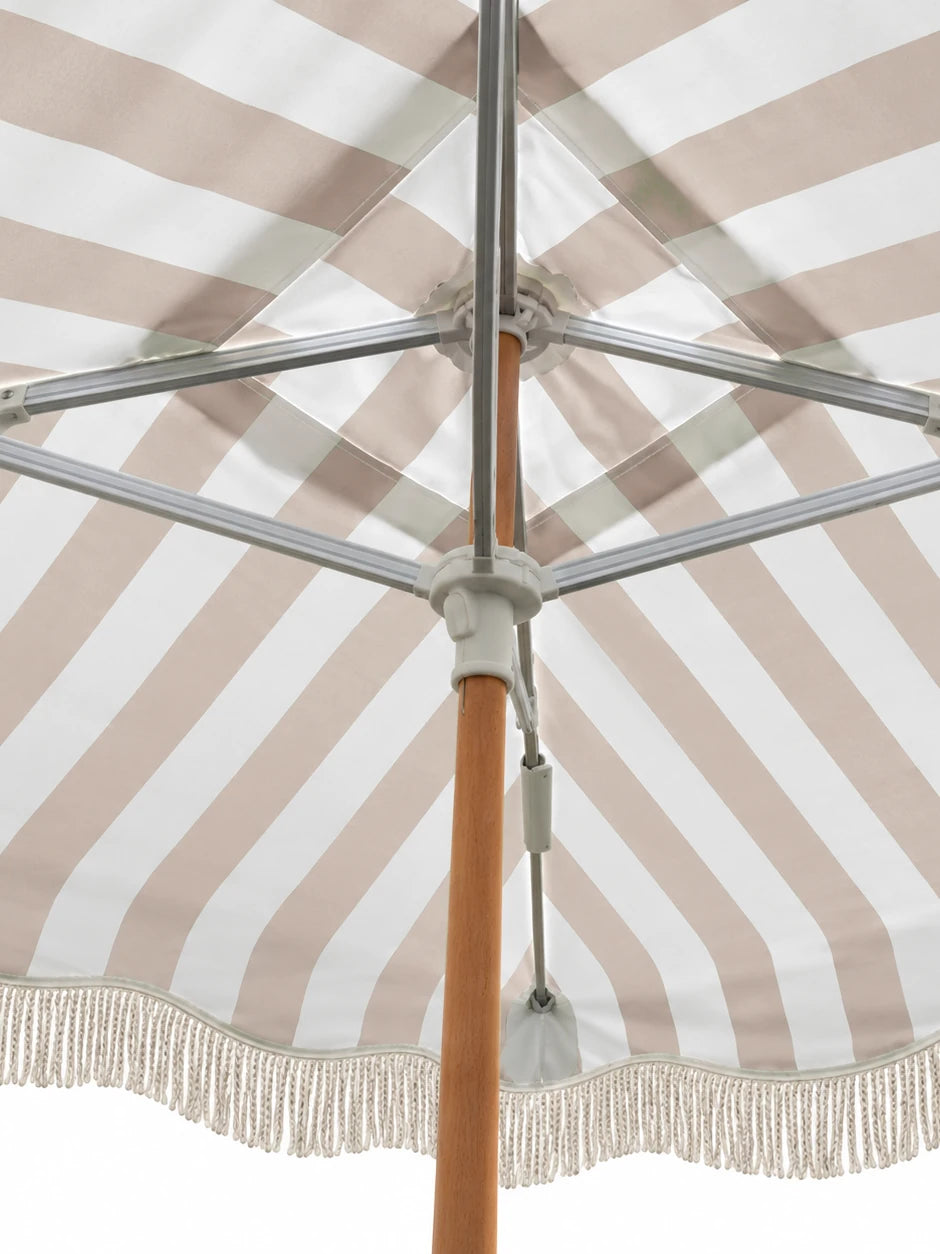 Underside of the House of Dune Sand Drift cabana roof: aluminium arms run from the hub on the wooden pole to each corner of the striped canopy.