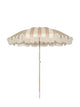 Upright Sand Drift beach umbrella from House of Dune with neutral beige and cream stripes, wooden pole, and fringe edging.