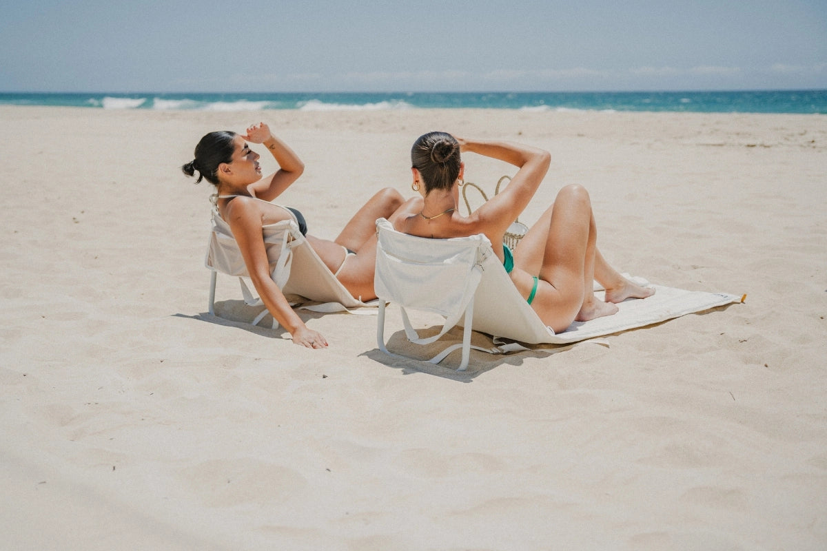 Sand Drift padded beach lounger with adjustable aluminium backrest and foldable three-section design, made with recycled waterproof canvas fabric.