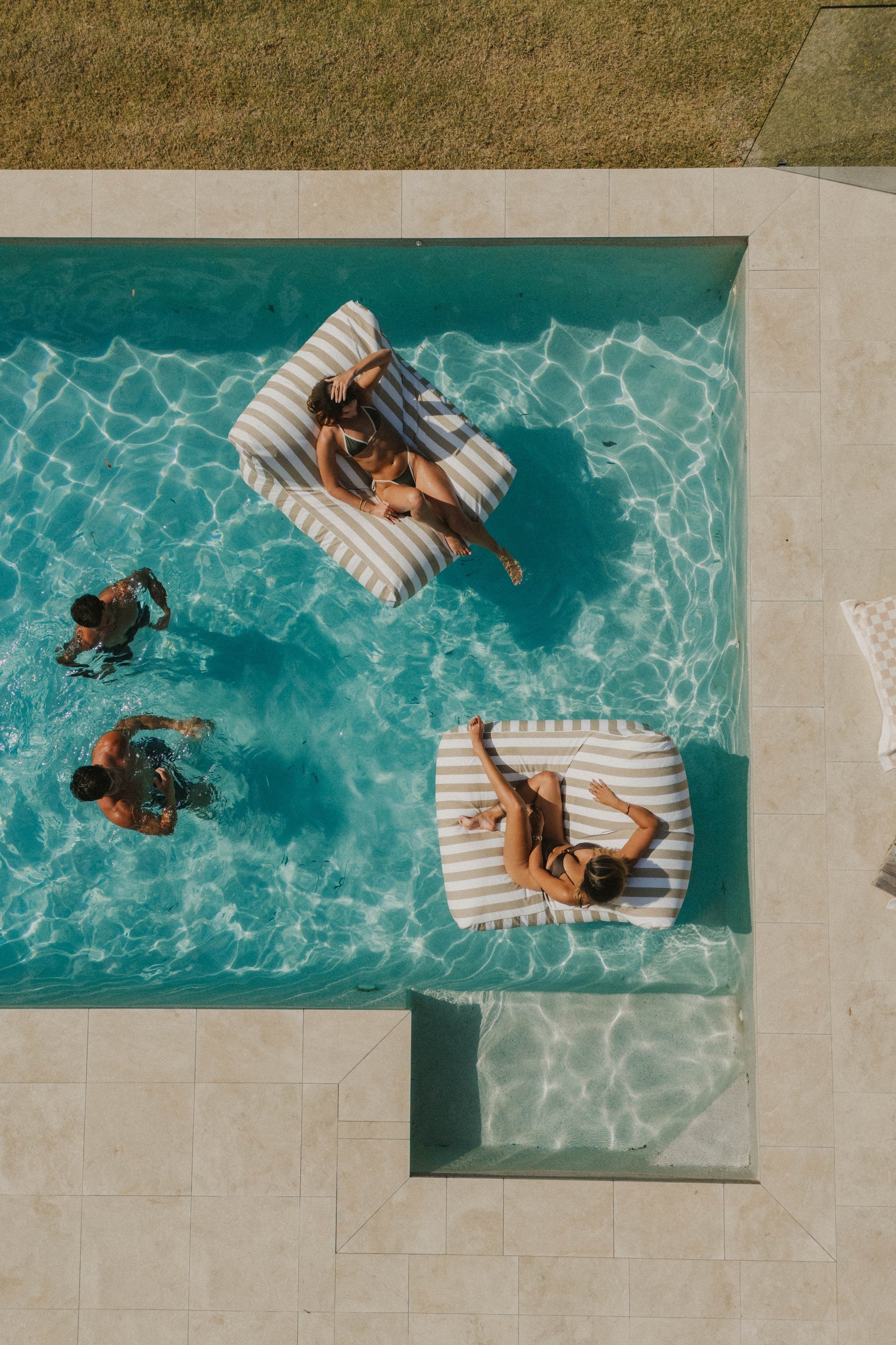 Floating Loungers on a pool, seen from above