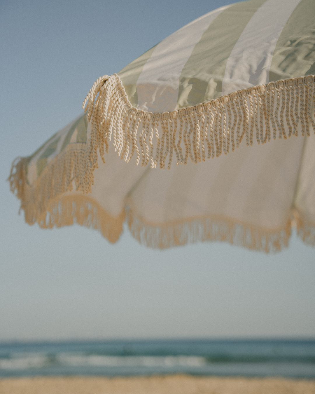 The cotton fringe of a Beach Umbrella against the sky